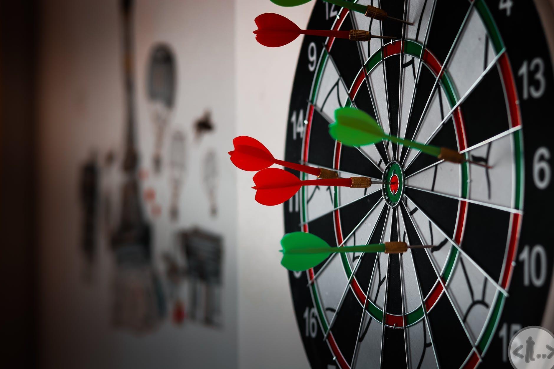 close up photo of dart pins on dartboard